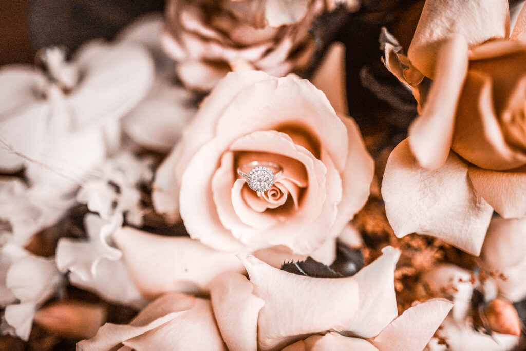 wedding ring on blush roses
